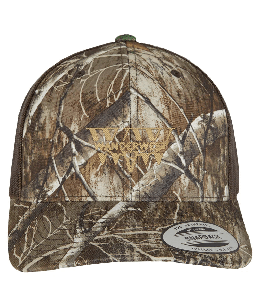 Legacy Mark Camo Trucker - WanderWest Woodland camo finished with gold WanderWest embroidery. The Legacy Mark carries a bit more weight. Same grit, just elevated. The gold thread gives it a heritage feel — like something you’ve had for years, even when it’s brand new. Quiet statement. Strong presence. Woodland camo base Gold WanderWest embroidery Structured front Adjustable fit Part of the mark you build over time.
